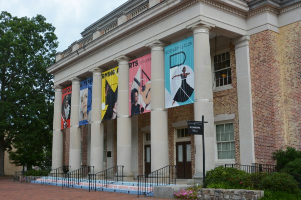 Memorial Hall, CPA's largest venue, is a brick building with large coiumns in the front and a colorful banner hanging from the roof.