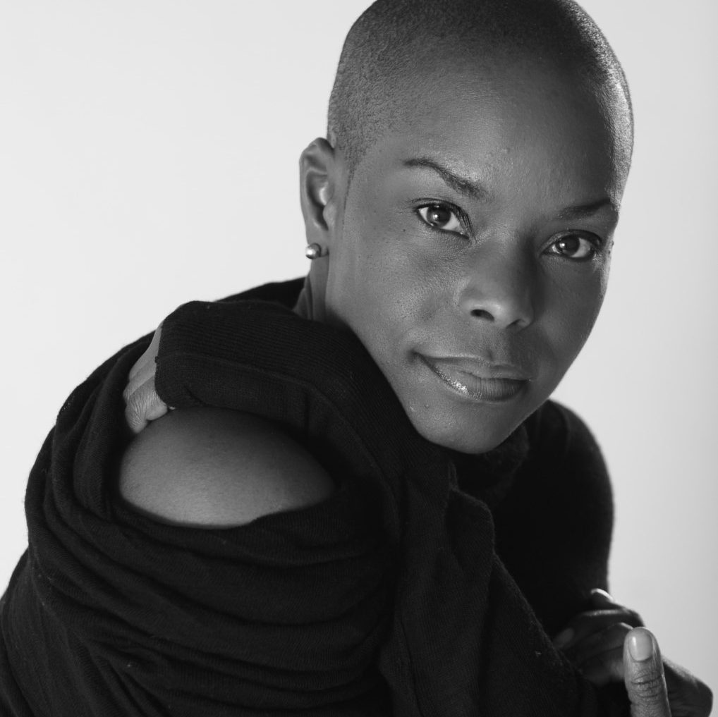 Dancer Hope Boykin looks at the camera wearing a off-the-shoulder black sweater.