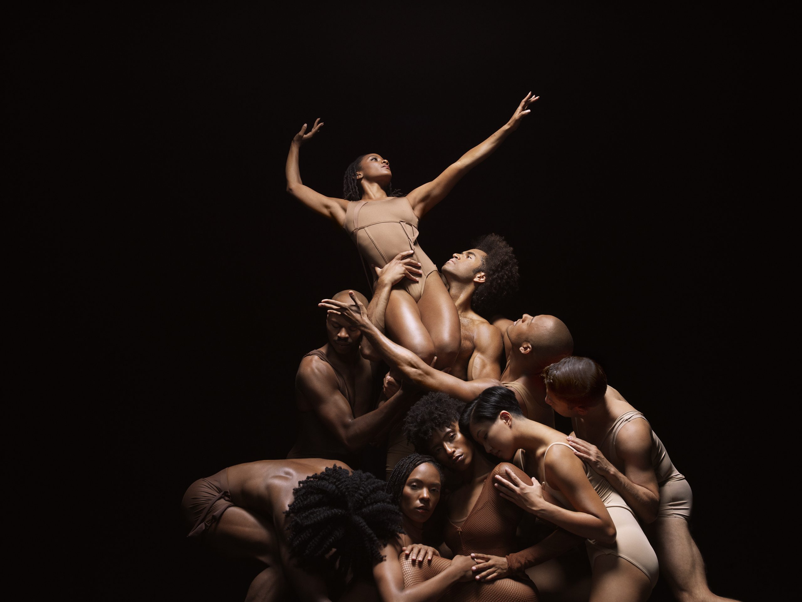 Dancers from Alvin Ailey American Dance Theater strike a dramatic pose.