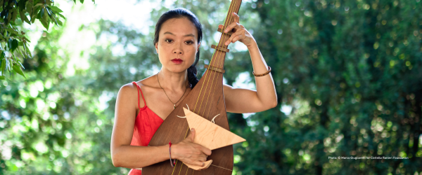 Jen Shyu poses with a stringed instrument.
